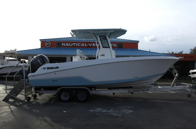 Slide: The Image of 2025 Wellcraft 243 Fisherman boat on trailer at Nautical Ventures dealership. - 4