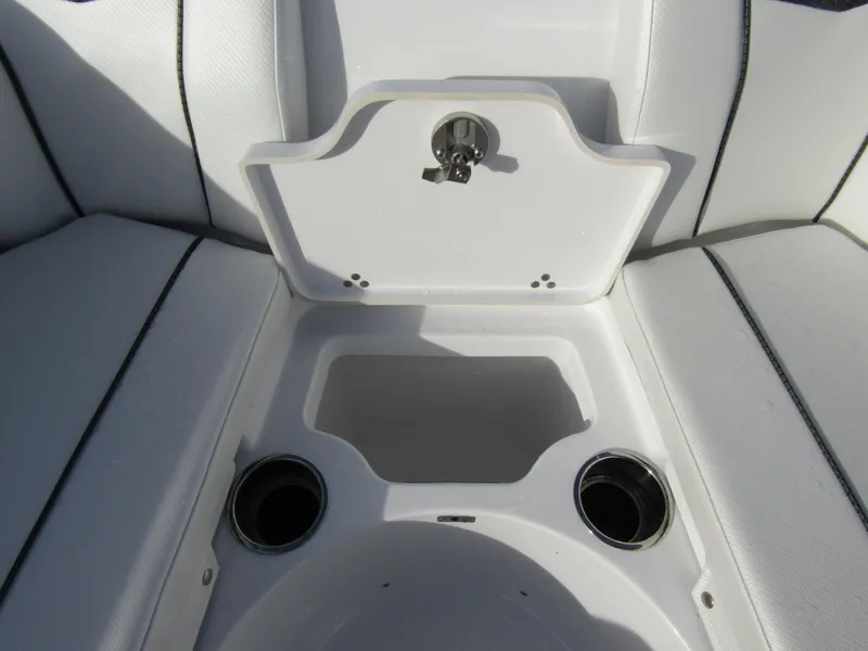 Slide: The Image of 2025 Wellcraft 243 Fisherman boat seating area with cup holders and storage compartment. - 11