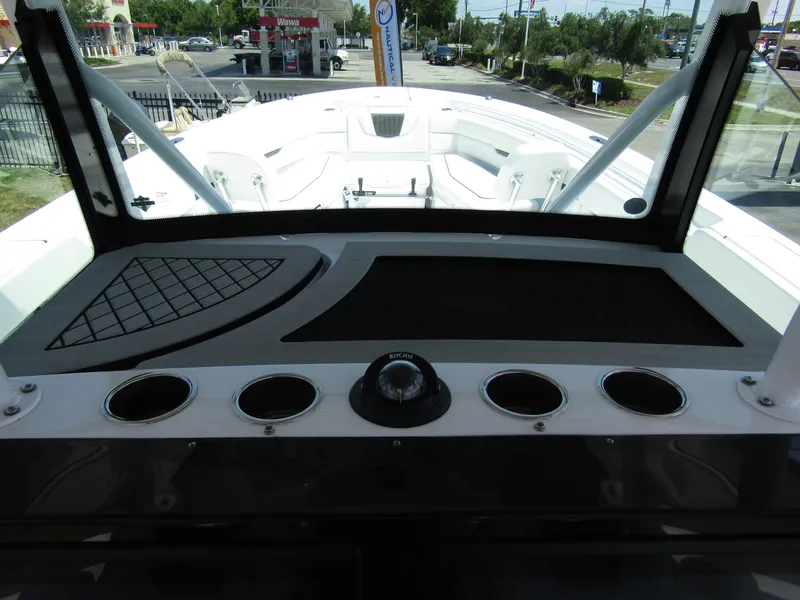 Slide: The Image of 2024 Wellcraft 352 Fisherman boat dashboard with cup holders and navigation equipment. - 18