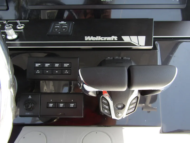 Slide: The Image of 2024 Wellcraft 352 Fisherman boat control panel and throttle. - 27