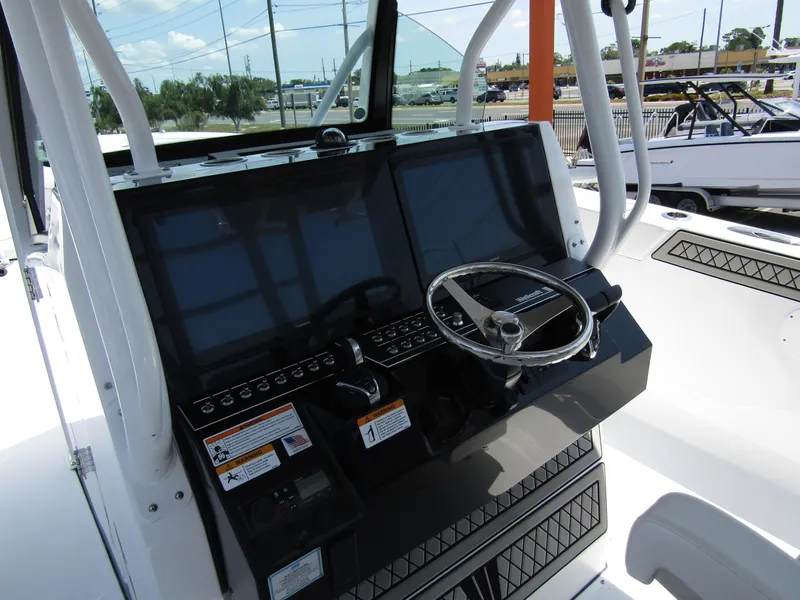 Slide: The Image of 2024 Wellcraft 352 Fisherman boat dashboard with dual screens and steering wheel. - 17