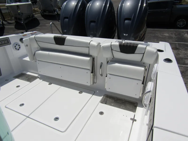 Slide: The Image of 2024 Wellcraft 352 Fisherman boat with triple outboard engines and foldable rear seating. - 30