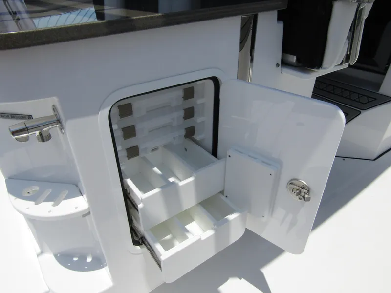 Slide: The Image of 2024 Wellcraft 352 Fisherman boat storage compartment with open drawers. - 37