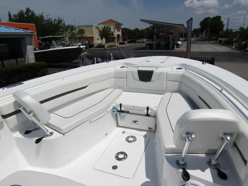 Slide: The Image of 2024 Wellcraft 352 Fisherman boat interior with white seating and storage compartments. - 6