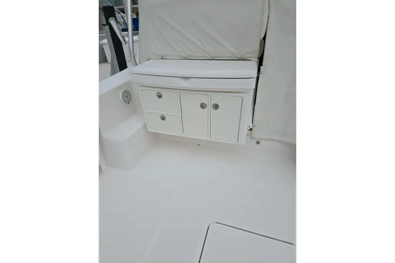 Slide: The Image of 2006 Tiara Yachts 3600 Open interior with white storage cabinets and seating. - 10