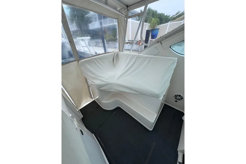 Slide: The Image of 2006 Tiara Yachts 3600 Open interior with covered seating and clear windows. - 14