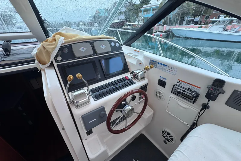 Slide: The Image of 2006 Tiara Yachts 3600 Open helm with dual screens and steering wheel. - 17