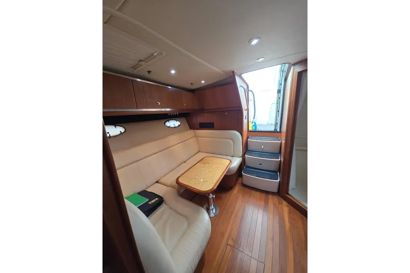 Slide: The Image of Interior of 2006 Tiara Yachts 3600 Open, featuring elegant seating and wooden finishes. - 23