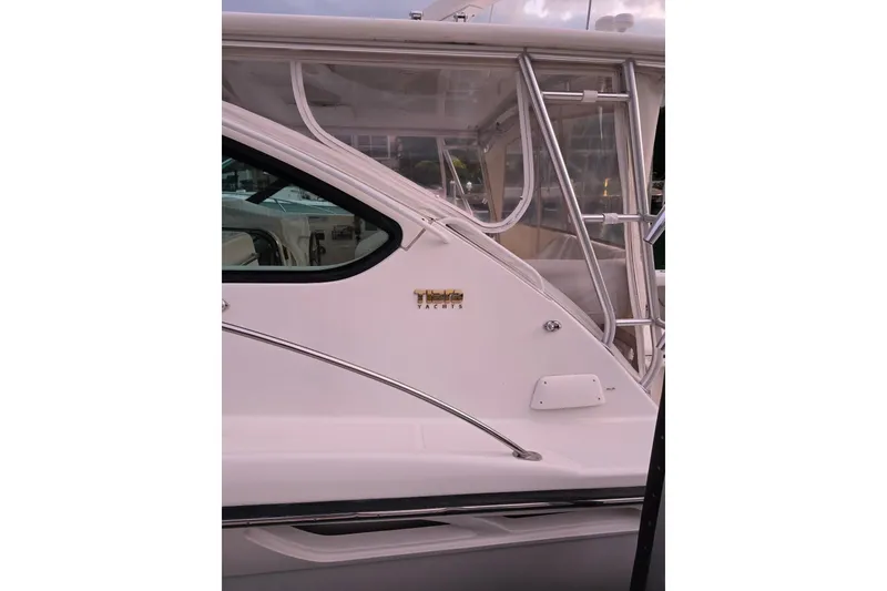 Slide: The Image of 2006 Tiara Yachts 3600 Open, side view with logo and window details. - 3