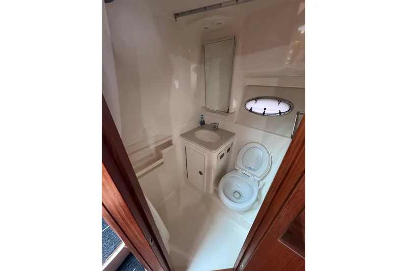 Slide: The Image of 2006 Tiara Yachts 3600 Open bathroom with sink, toilet, and porthole window. - 31