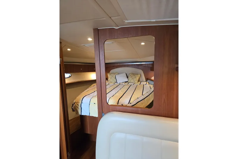 Slide: The Image of 2006 Tiara Yachts 3600 Open cabin interior with cozy bed and wooden accents. - 32