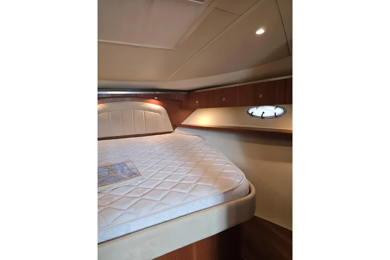 Slide: The Image of 2006 Tiara Yachts 3600 Open cabin interior with bed and porthole window. - 33