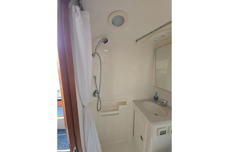 Slide: The Image of 2006 Tiara Yachts 3600 Open bathroom with shower, sink, and mirror. - 36
