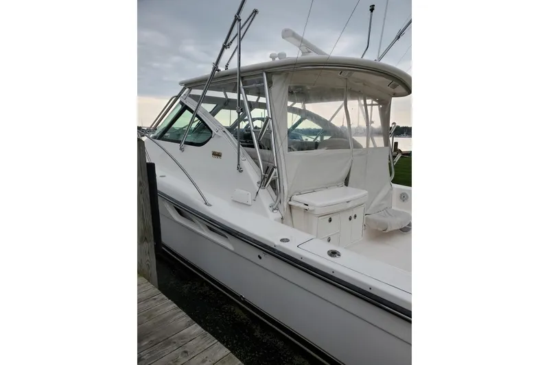 Slide: The Image of 2006 Tiara Yachts 3600 Open docked, showcasing sleek design and spacious deck. - 4