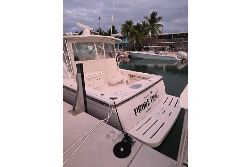 Slide: The Image of 2006 Tiara Yachts 3600 Open docked at marina with palm trees in background. - 5