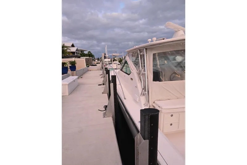 Slide: The Image of 2006 Tiara Yachts 3600 Open docked, showcasing sleek design and spacious deck. - 6