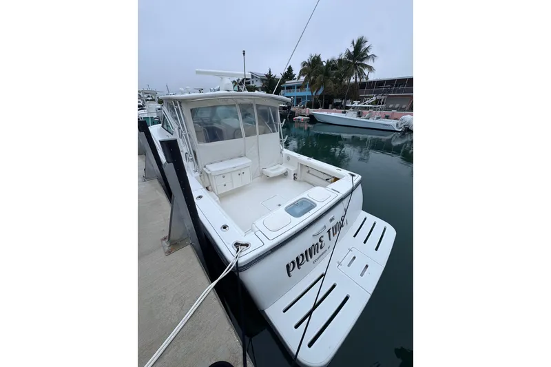 Slide: The Image of 2006 Tiara Yachts 3600 Open docked, featuring spacious deck and sleek design. - 7