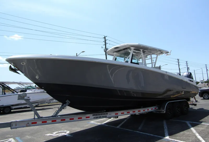 Slide: The Image of 2024 Wellcraft 352 Fisherman boat on a trailer in a parking lot. - 2