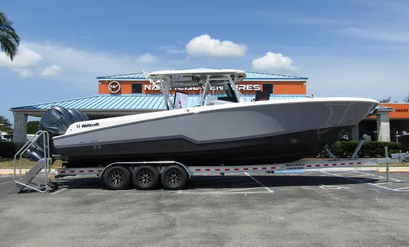 The Image of 2024 Wellcraft 352 Fisherman boat on a trailer in a parking lot. - 0