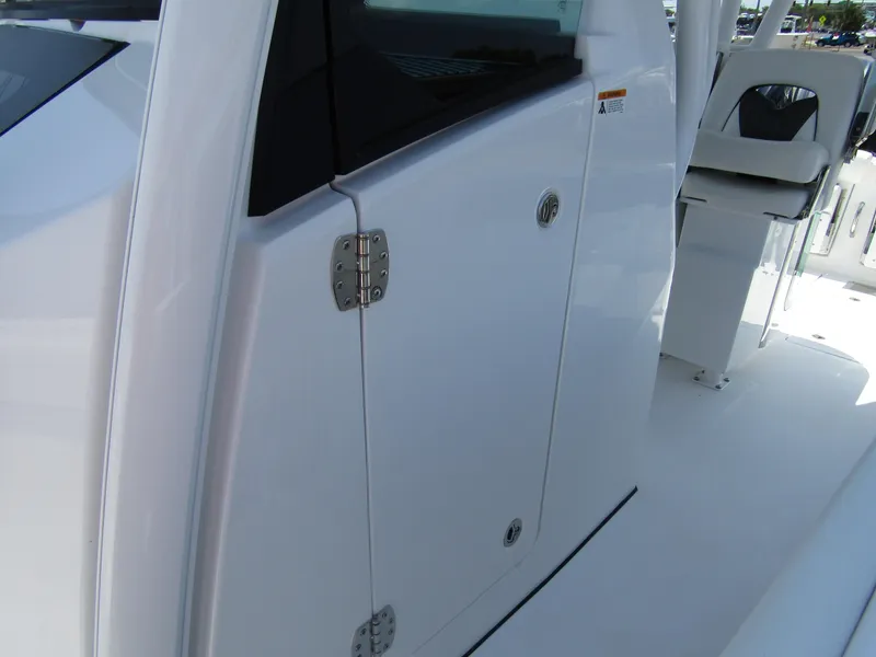 Slide: The Image of 2024 Wellcraft 352 Fisherman boat, close-up of cabin door and seating area. - 13