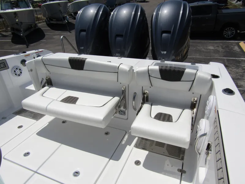 Slide: The Image of 2024 Wellcraft 352 Fisherman boat with triple outboard engines and foldable seating. - 31