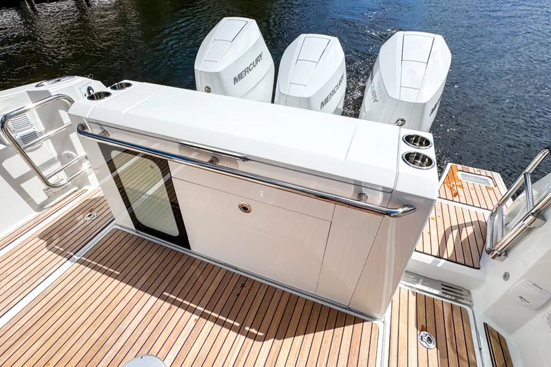 Slide: The Image of 2025 Wellcraft 38 Explorer boat deck with Mercury engines and sleek design. - 12