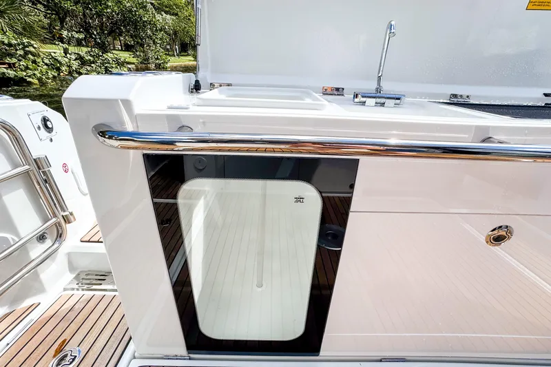 Slide: The Image of 2025 Wellcraft 38 Explorer boat deck with sleek design and stainless steel railing. - 14