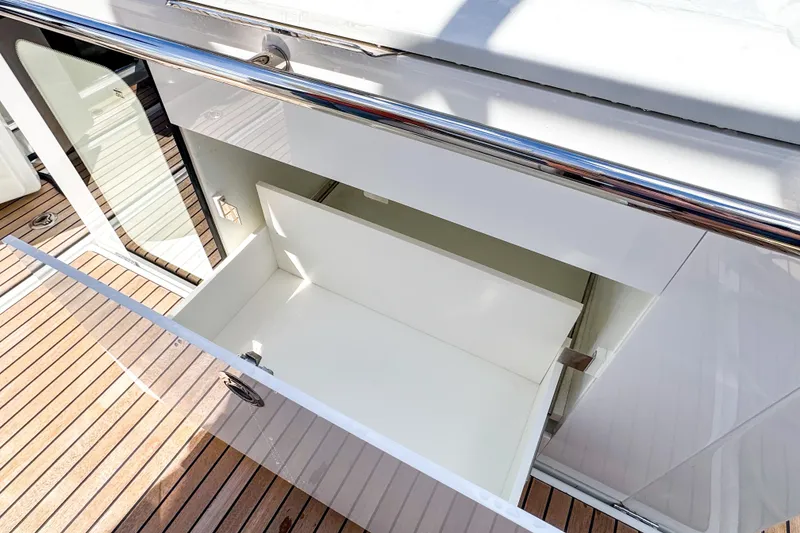 Slide: The Image of Open storage compartment on 2025 Wellcraft 38 Explorer yacht with wooden deck. - 15