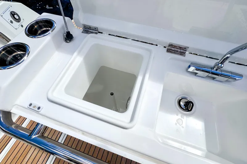 Slide: The Image of Wellcraft 38 Explorer 2025 boat sink and faucet with cup holders on deck. - 16
