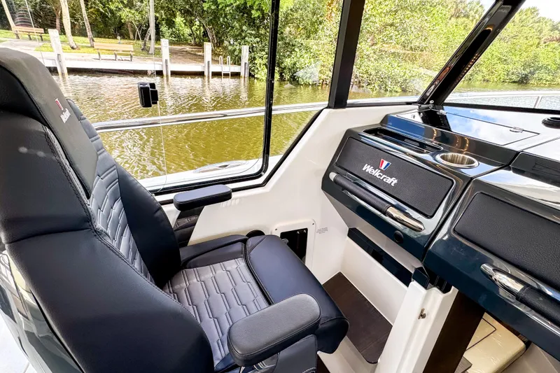Slide: The Image of 2025 Wellcraft 38 Explorer interior with sleek black seating and modern dashboard design. - 30