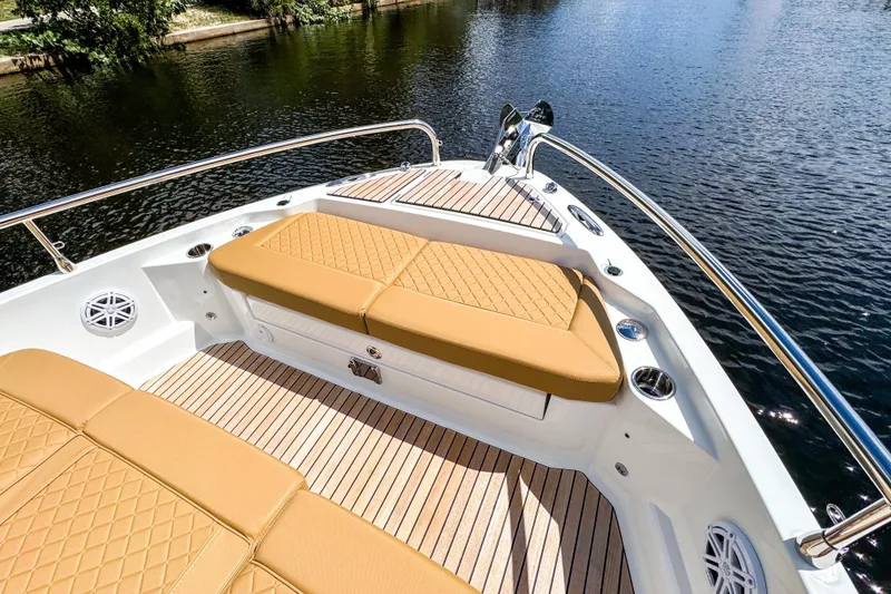 Slide: The Image of Luxurious 2025 Wellcraft 38 Explorer boat with tan cushioned seating on deck by the water. - 41