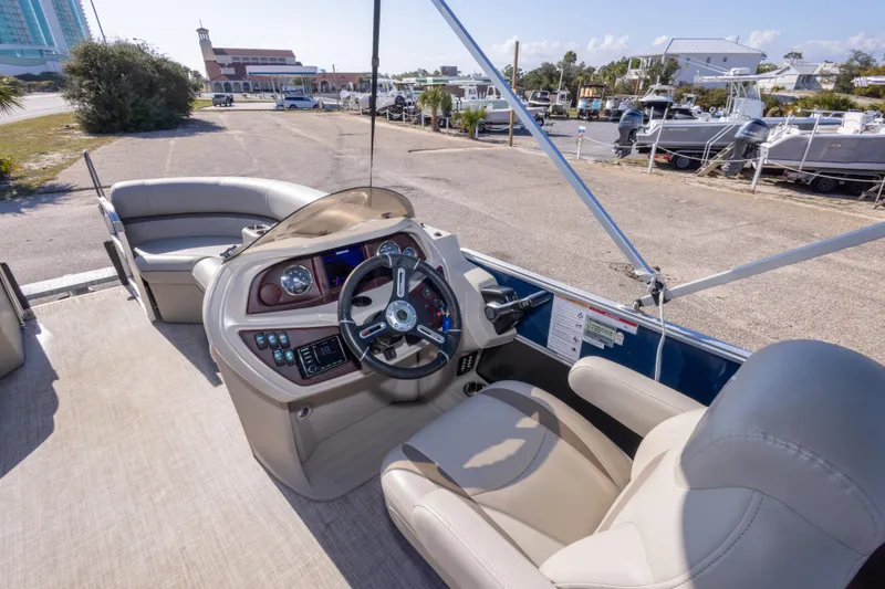 Slide: The Image of 2021 South Bay 222CR pontoon boat interior with steering console and seating. - 12