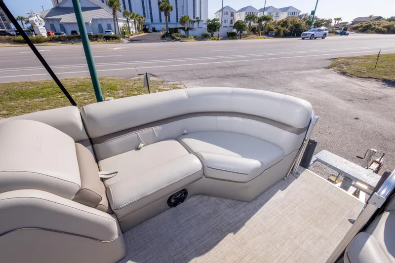Slide: The Image of 2021 South Bay 222CR boat interior with beige seating and street view. - 16