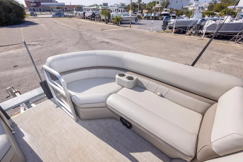 Slide: The Image of 2021 South Bay 222CR pontoon boat interior with beige seating and cup holders. - 17