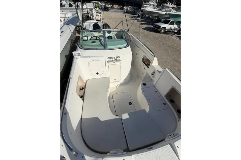 Slide: The Image of 2004 Hurricane SunDeck 260 OB boat with spacious seating and open deck layout. - 14