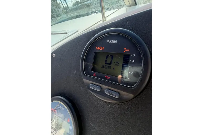 Slide: The Image of Yamaha tachometer on 2004 Hurricane SunDeck 260 OB boat, displaying 909 hours. - 19