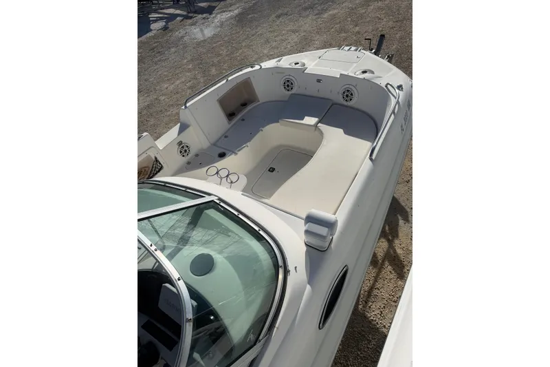 Slide: The Image of 2004 Hurricane SunDeck 260 OB boat interior with spacious seating and clean design. - 24