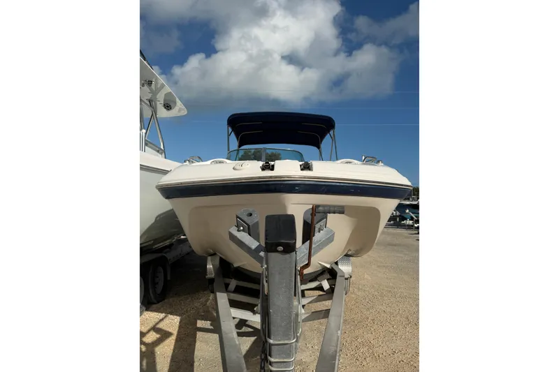 Slide: The Image of 2004 Hurricane SunDeck 260 OB boat on trailer under blue sky. - 3