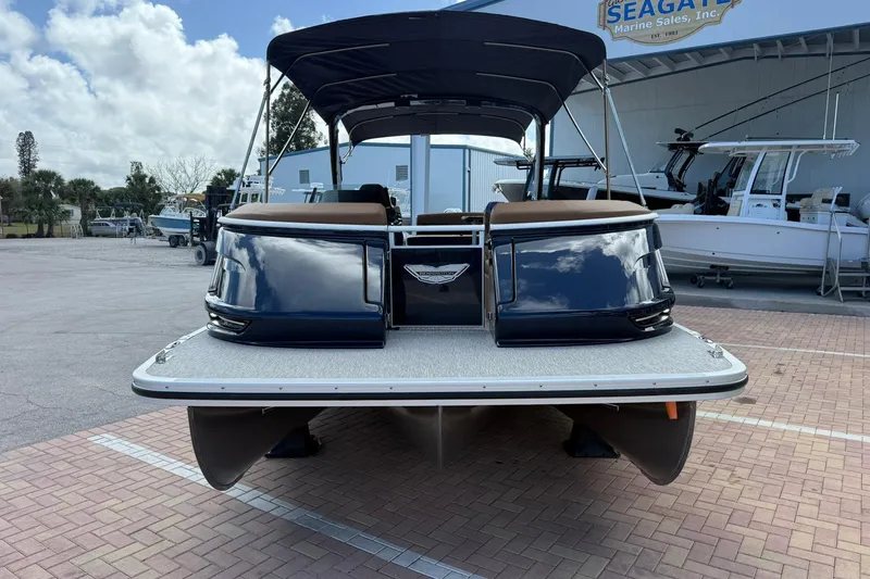 Slide: The Image of 2026 Bennington QX 30 QXSBA X2 Wide Beam pontoon boat at marina, rear view. - 2
