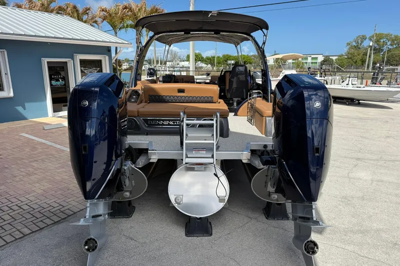 Slide: The Image of 2026 Bennington QX 30 QXSBA X2 Wide Beam boat with dual engines, docked outdoors. - 3