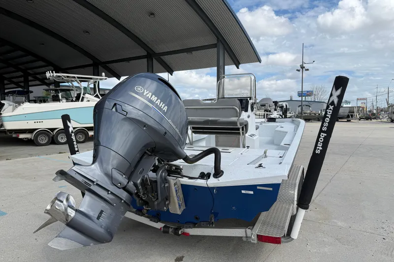 Slide: The Image of 2021 Xpress H24B Bay boat with Yamaha outboard motor, parked outdoors. - 3
