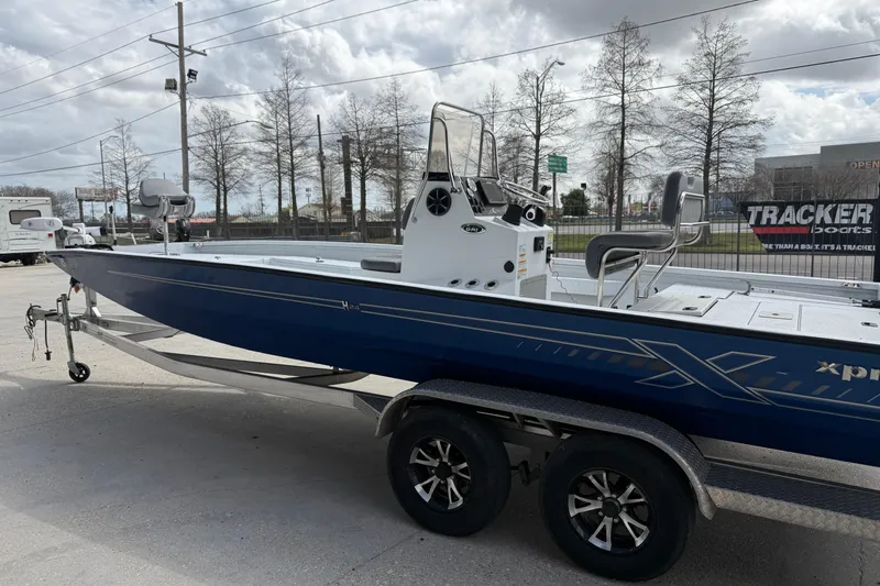 Slide: The Image of 2021 Xpress H24B Bay boat on trailer, parked outdoors. - 5