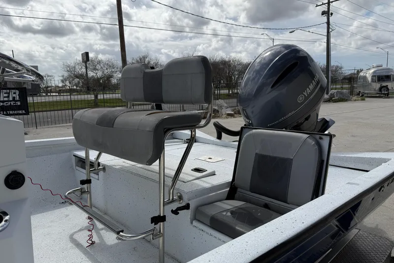 Slide: The Image of 2021 Xpress H24B Bay boat with Yamaha outboard motor and cushioned seating. - 6