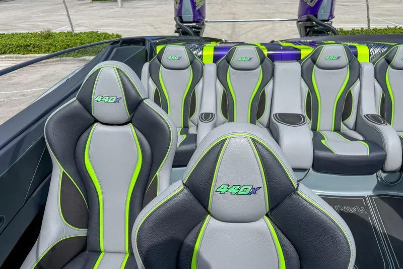 Slide: The Image of 2024 MTI 440X boat interior with sleek, modern seats featuring green accents. - 10