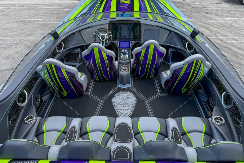 Slide: The Image of 2024 MTI 440X boat interior with vibrant green and purple seating, sleek design. - 5