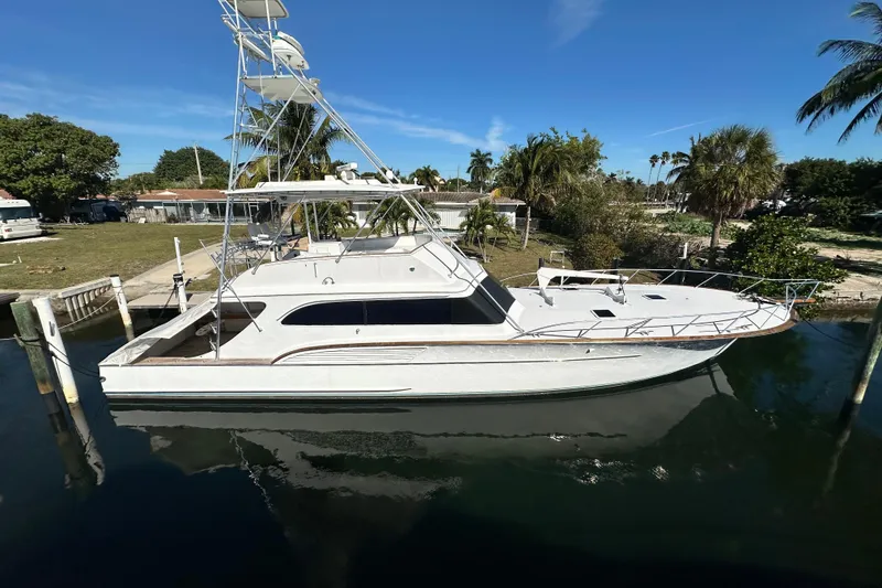 The Image of 1996 Buddy Davis 67 yacht docked in a serene marina setting. - 0