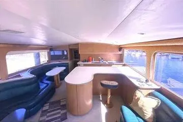 Slide: The Image of Interior of 1996 Buddy Davis 67 yacht with modern seating and kitchen area. - 11