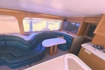 Slide: The Image of Interior of 1996 Buddy Davis 67 yacht with curved seating and dining table. - 13