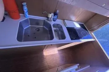 Slide: The Image of 1996 Buddy Davis 67 yacht kitchen with dual sinks and stovetop. - 14