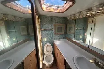 Slide: The Image of Bathroom interior of 1996 Buddy Davis 67 yacht with skylight and mirrored cabinets. - 17